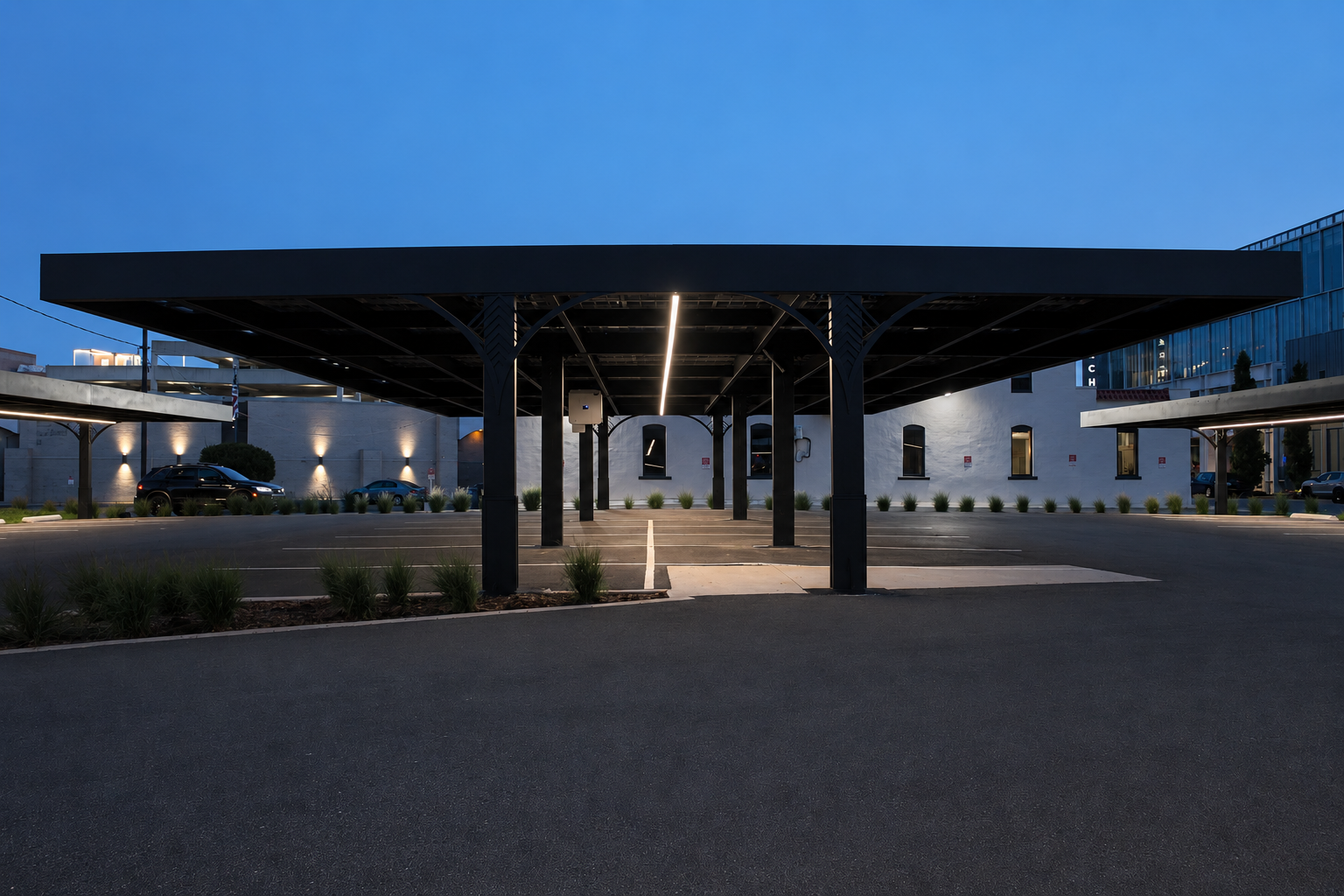 Full solar carport structure lit at dusk, Stryker Building