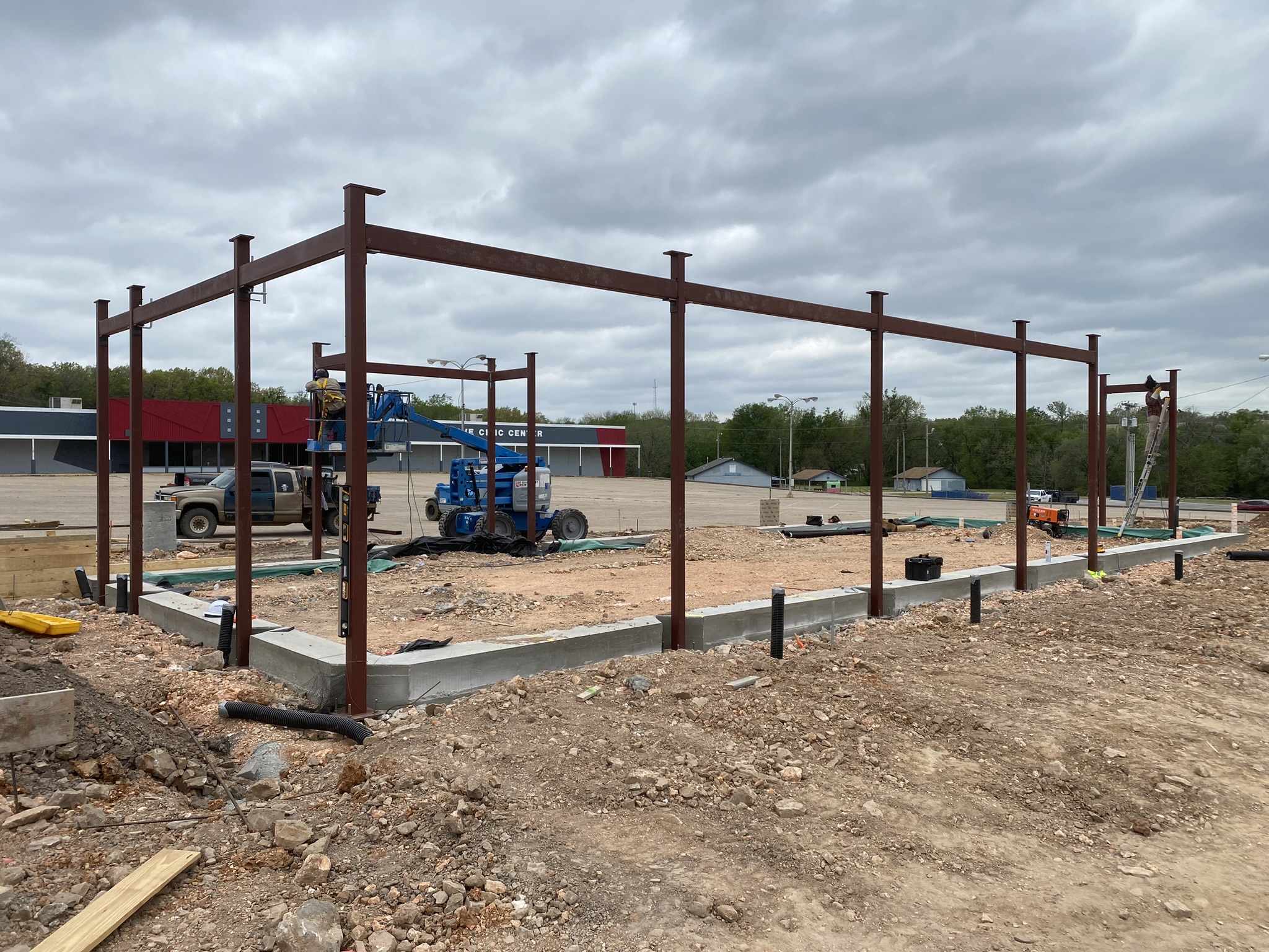 Red-primed structural steel frame erected on new footings at a commercial job site